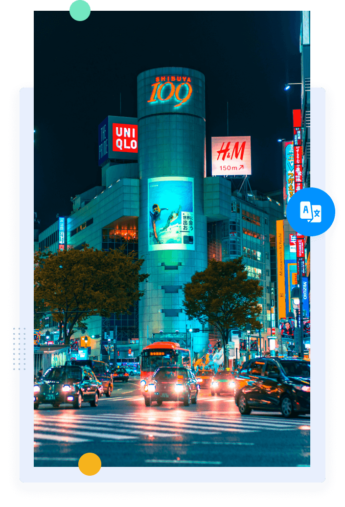 A busy street at night in Japan filled with bright lights, neon signs, pedestrians and vehicles outside buildings.